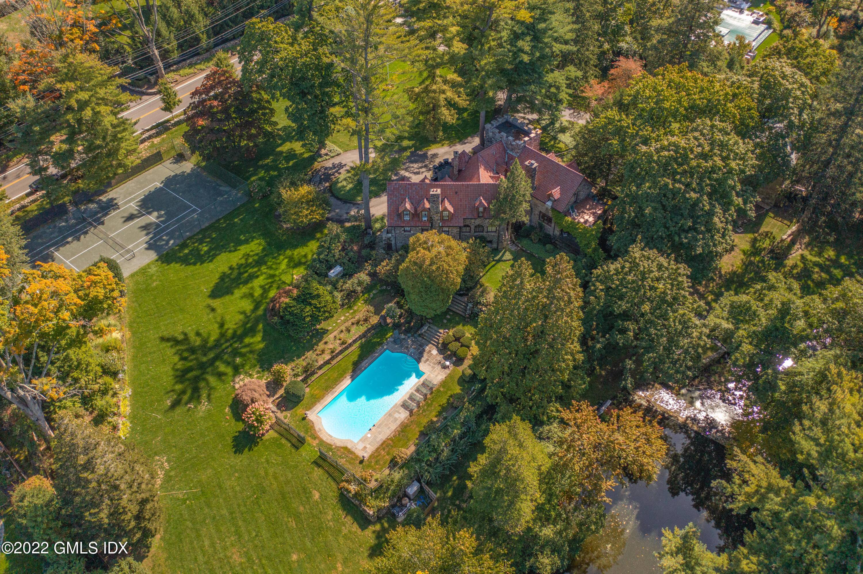 This impressive Stone Manor has a stately presence in Mid Country on beautiful Lake Ave.