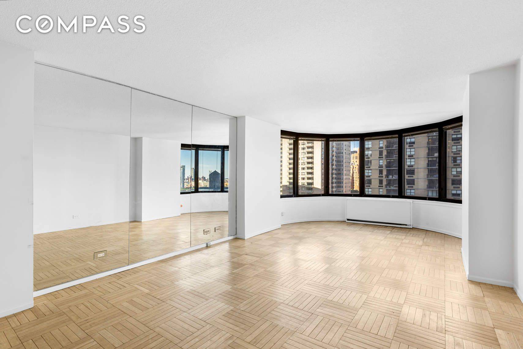 Oversized studio with wall to wall windows featuring Stunning East River views.