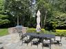 View of patio / terrace with outdoor dining space, an outdoor kitchen, and view of scattered trees