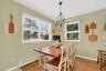 Dining room with baseboard heating, healthy amount of natural light, and light wood-style flooring