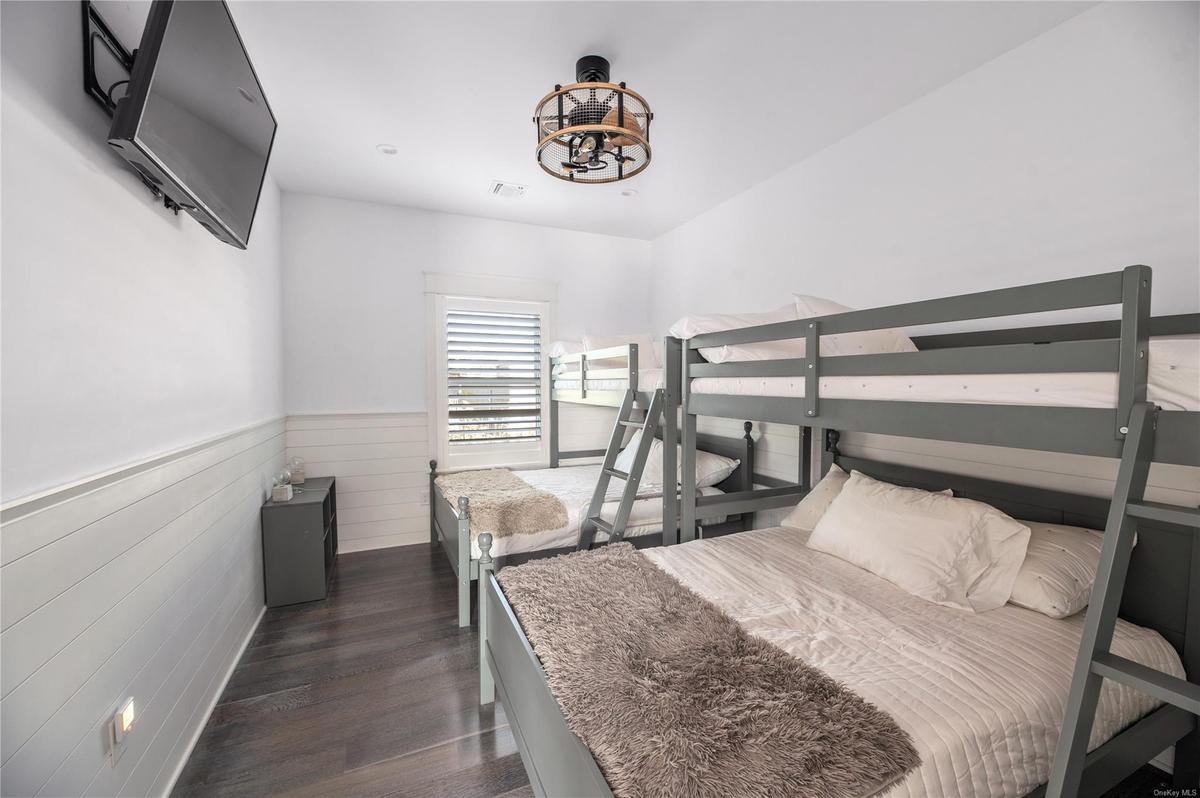 Bedroom with dark wood-type flooring