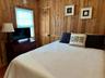 Bedroom featuring wooden walls