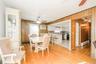 Dining area with wood-finish flooring and paneled walls