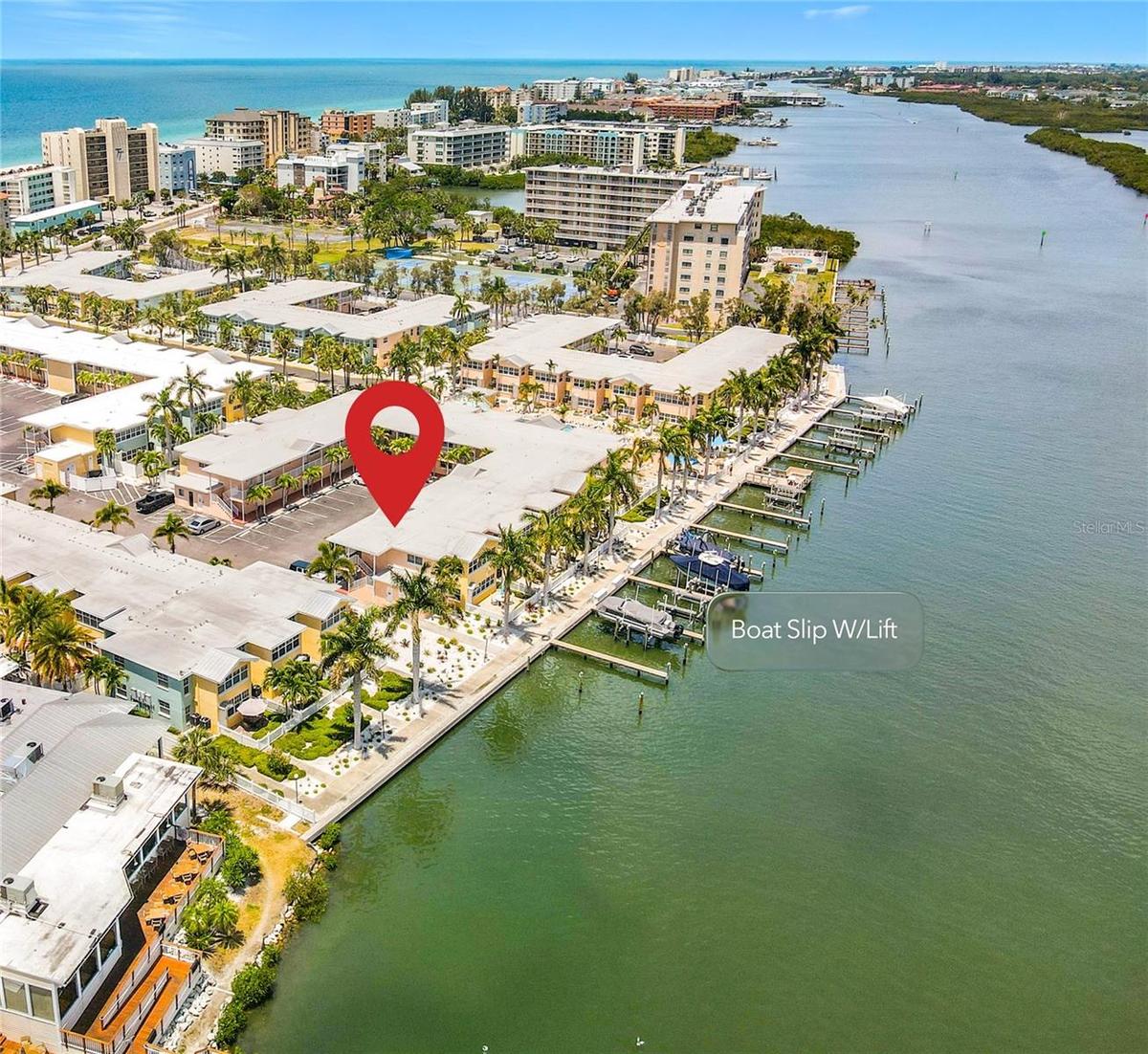 This aerial view shows the unit location and the boat slip with lift location that conveys with this unit.