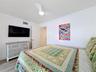 Another look at the 2nd bedroom that does have a television mounted on the wall that conveys with the sale