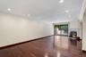 Spacious interior room featuring rich wood-finish flooring, recessed lighting, and white crown molding
