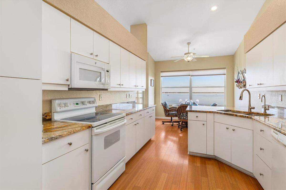Tons of storage in this kitchen, connected to the breakfast bar and nook overlooking the water