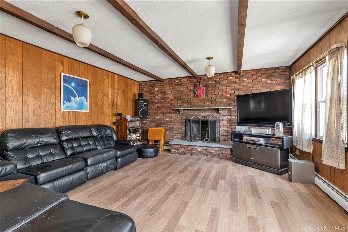 Family room with wood burning fireplace. Great option for formal dining room.
