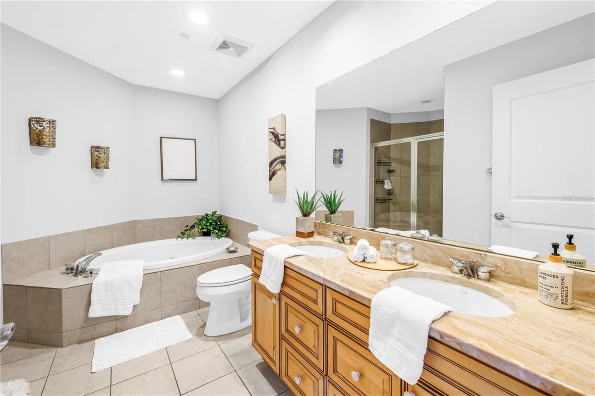 Right Primary Garden Tub and Dual Granite Vanity. Notice the Large Walk-In Shower Image