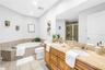 Right Primary Garden Tub and Dual Granite Vanity. Notice the Large Walk-In Shower Image