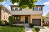 Split-level residence featuring a brick and siding facade, an attached single-car garage, and a concrete driveway