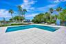 Beautifully renovated pool area featuring an outdoor kitchen, open-air cabanas and convenient outdoor showers. The perfect setting for relaxing, enter