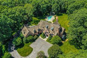 Exceptional custom built brick manor home beautifully situated on 4 very private acres.