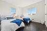 Bedroom with dark hardwood / wood-style flooring