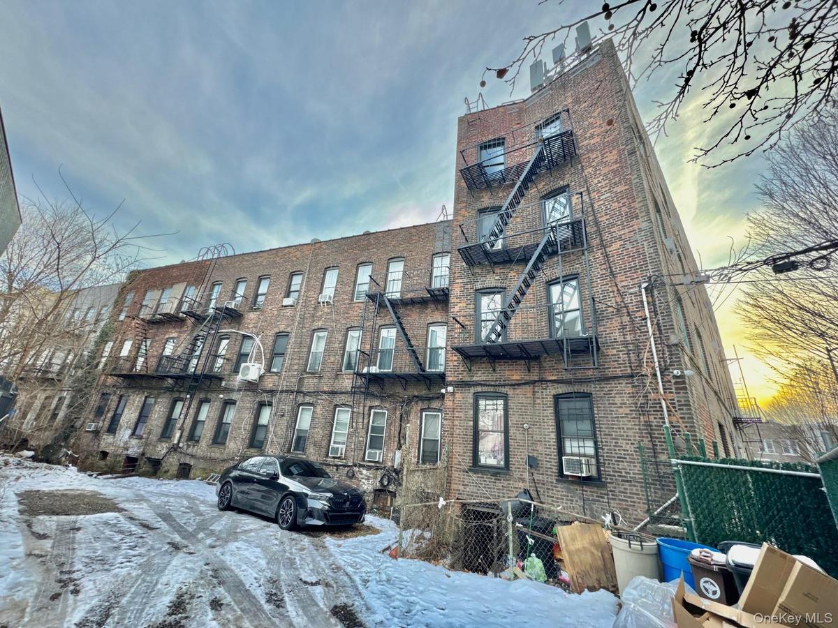 Snow covered building with a view of apartment building / complex