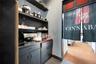 Bar area featuring light tile patterned flooring and gray cabinetry