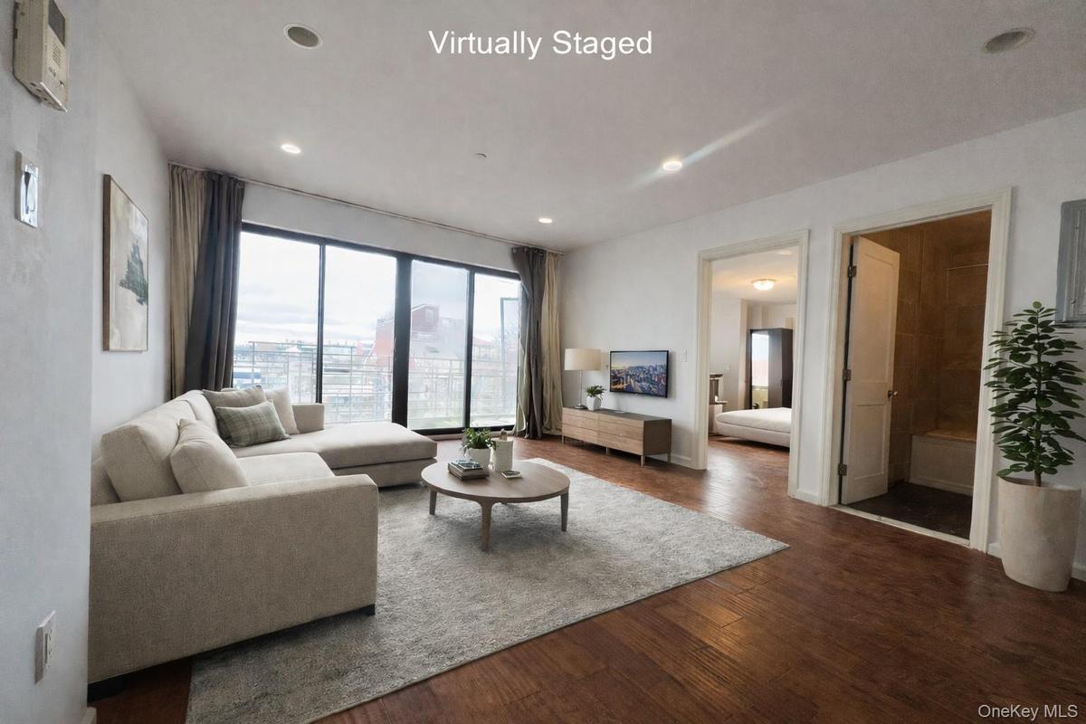 Living room with dark wood-type flooring and recessed lighting