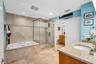 Large Primary Suite Bathroom with Jacuzzi jetted tub, Shower with seat and two-Separate Sinks Basin's and three Closets with Built-Ins