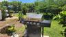 Out front, directly next to this condo's covered parking space, is a shared gas grill and kayak storage