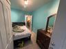 Bedroom featuring light tile patterned floors and baseboards