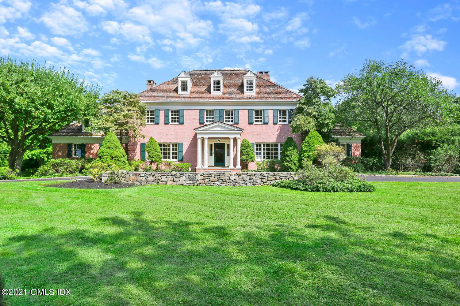 Impressive 8, 238 square foot brick clad Colonial, designed with relaxed living and entertaining in mind, graces four private, scenic acres.