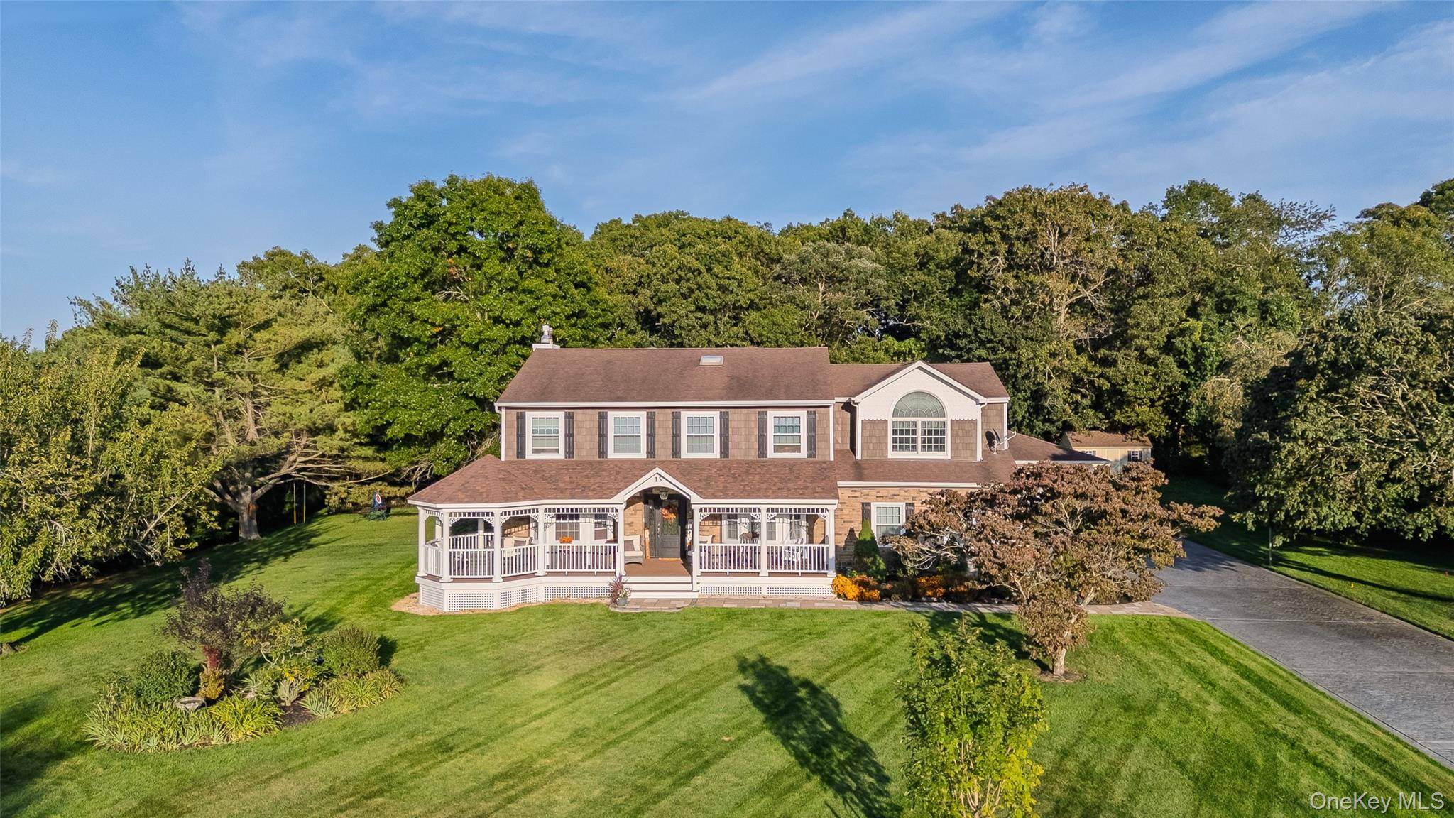 Location ! Location ! Welcome to this exquisite 5 bedroom, 4 bathroom Colonial estate set on a beautifully landscaped property in the highly sought after community of Manorville.