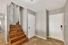 Stairs to first level. Door to right goes out side. middle door is storage.