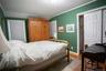 Bedroom featuring wood finished floors, a closet, and ornamental molding