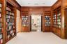 The library with double wooden doors going into the formal living room and on the right doors going into the private family/TV room with built-ins.