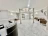A BEAUTIFULLY APPOINTED LOBBY WITH ELEVATOR AND ENTRANCE TO GARAGE