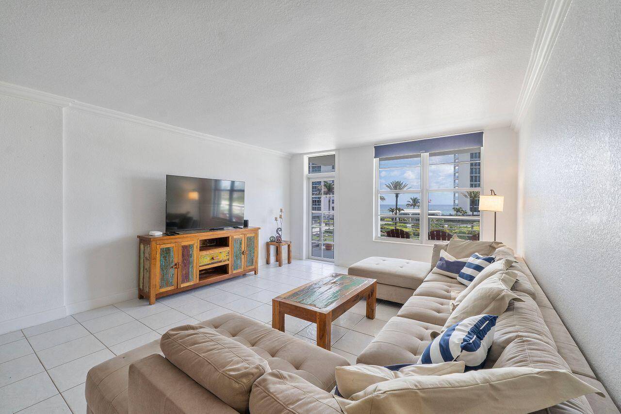 Experience coastal living in this beautifully appointed corner unit, ideally located just a short stroll from the vibrant Deerfield Beach pier, shops, and restaurants.