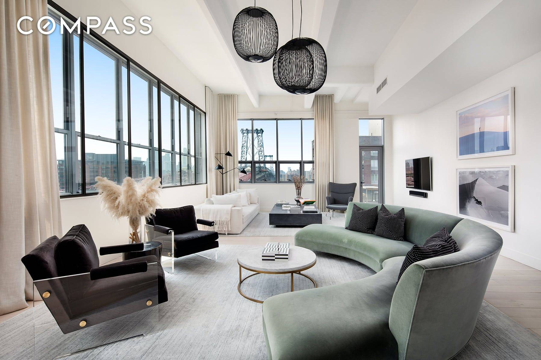 The penthouse at 338 Berry in South Williamsburg offers an incredible 42 foot living room with walls of windows that overlook the East River and downtown Manhattan skyline.