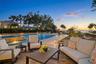 Resort-style pool and waterfront living with sunset views.