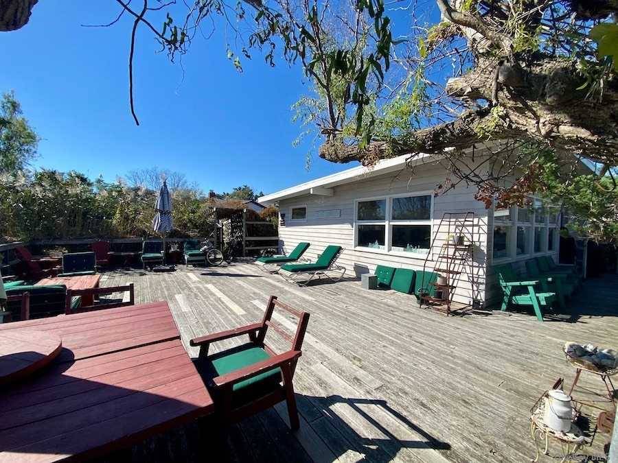 This Fair Harbor beach cottage sits on a large lot surrounded by foliage that makes it completely private.