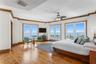Primary bedroom — wrap around windows, bay views