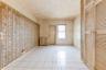 Empty room featuring crown molding, baseboards, and light tile patterned floors