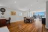 Spacious open-concept living area featuring wood-finish flooring and recessed lighting