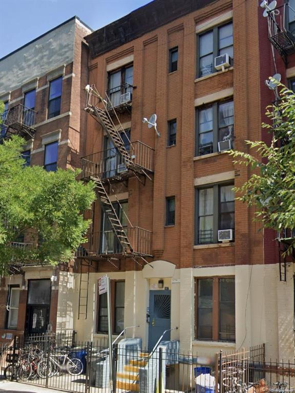 View of apartment building / complex featuring cooling unit