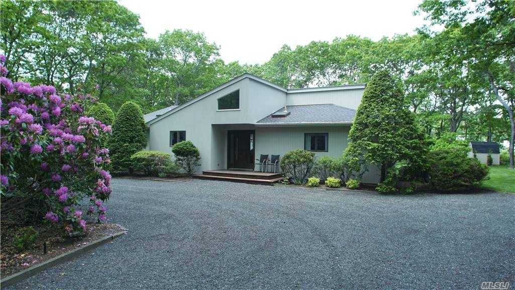 Quintessential Quogue Village Home Tucked away on almost an acre of professionally manicured property, this 3 bedroom, 2 bath home awaits.