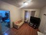 Living area featuring wood finished floors and ornamental molding