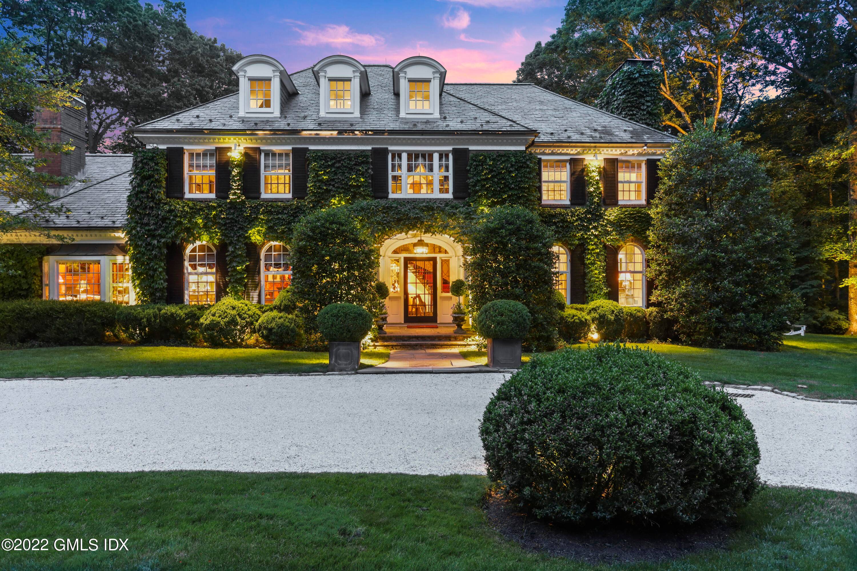 Majestic four bedroom Georgian Colonial graces two private acres with expansive stone terrace and pool tucked back off a coveted lane close to town.