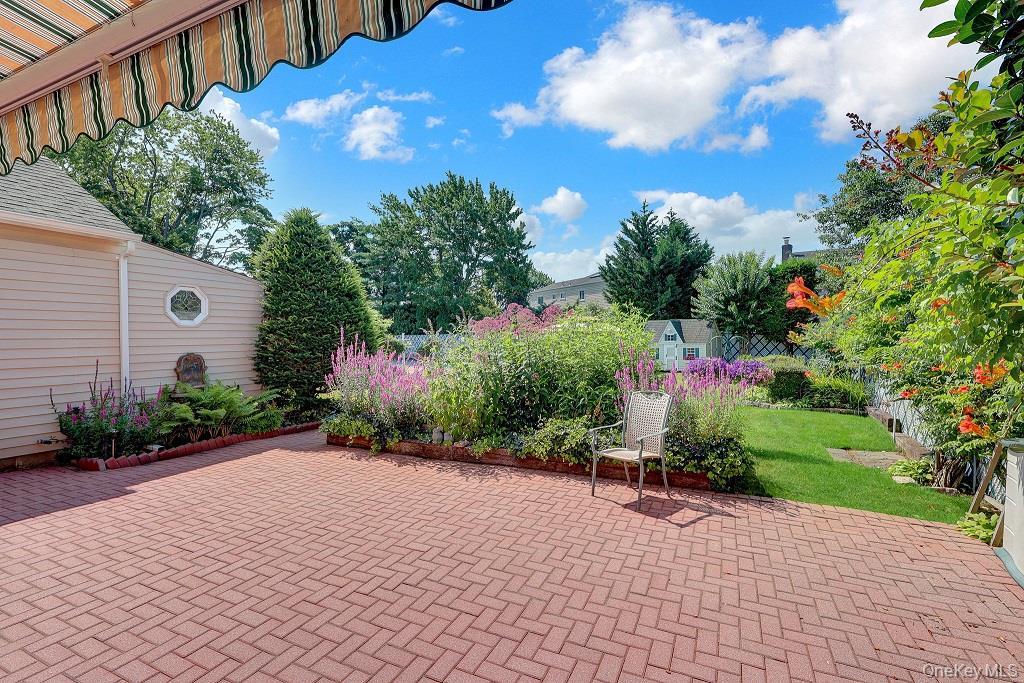 Brick patio with retractable electric awning