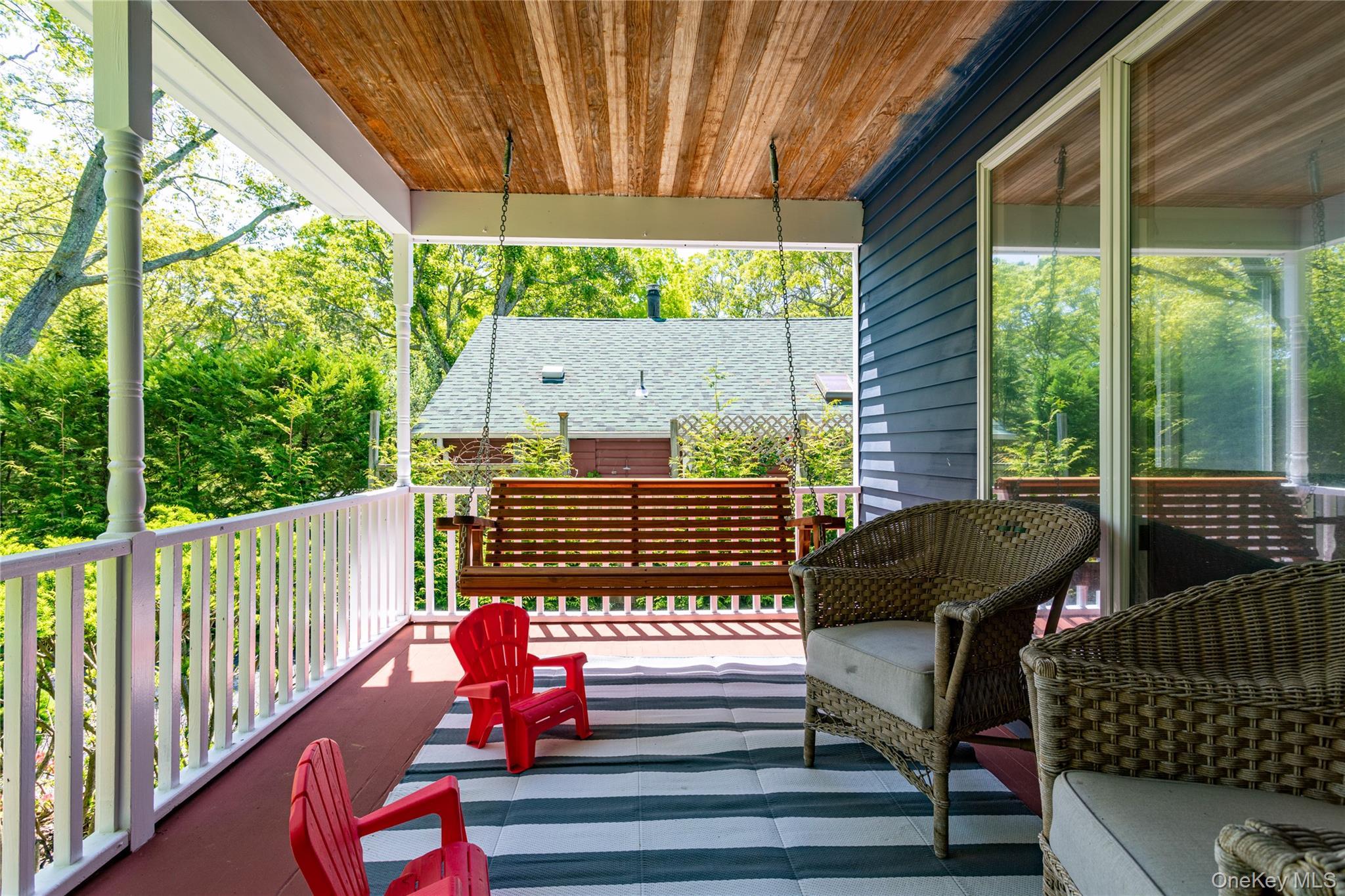 Inviting Covered Front Porch with Courtship Swing