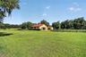 Groomed Backyard with Playground and 5-Stall Center-Aisle Barn