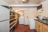 Laundry area with brick patterned flooring and separate washer and dryer