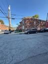 View of asphalt street with sidewalks, curbs, and street lighting