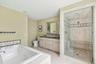 Bathroom with double vanity, a whirlpool tub, a shower stall, recessed lighting, and tile patterned floors