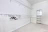 Spacious walk-in closet featuring light carpet