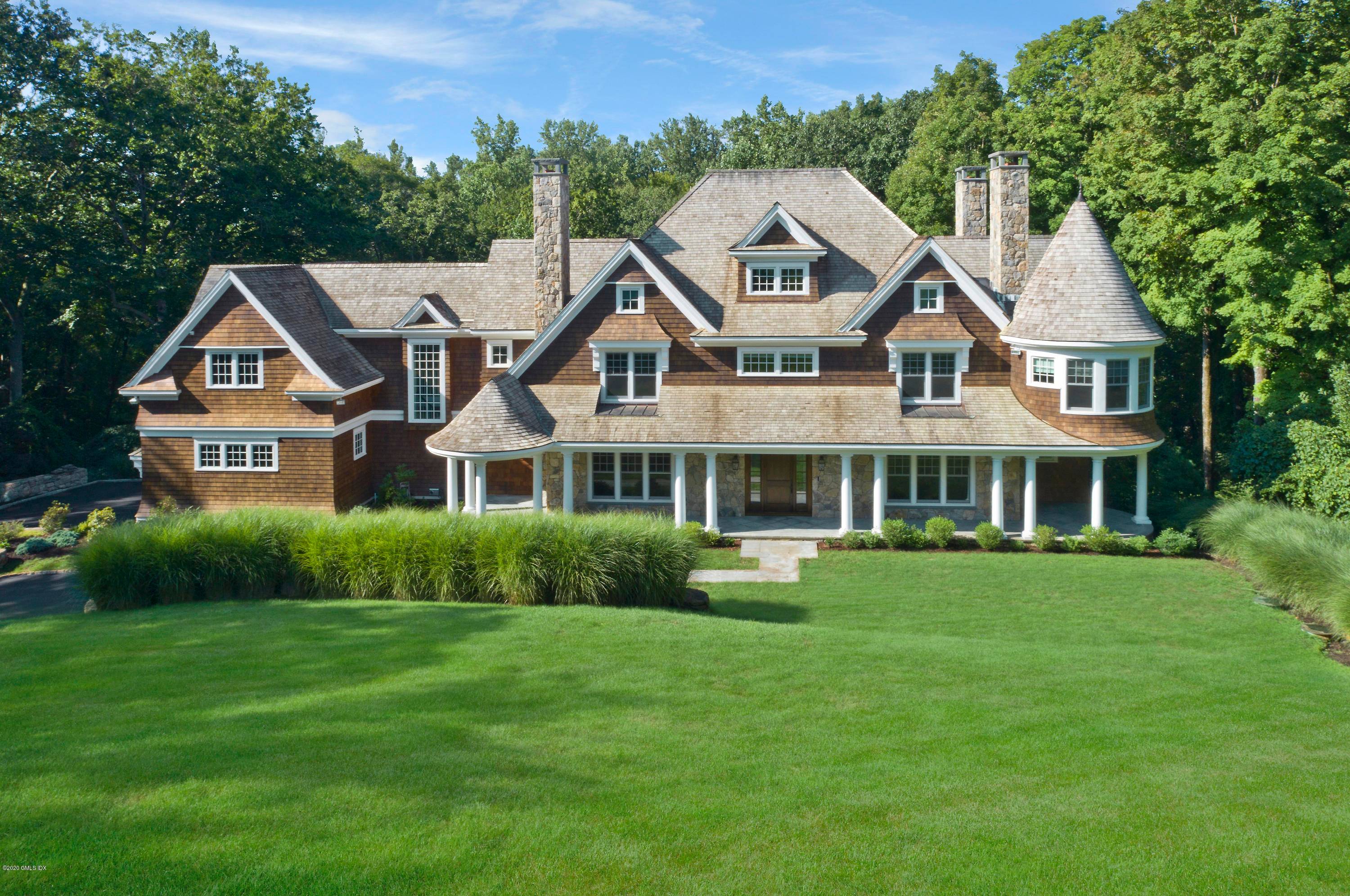 Set in a premier Back country location, this stunning Cosmopolitan New England shingle style residence was designed by Steven Mueller architects, HOBI award winner for Best Spec Home in CT.