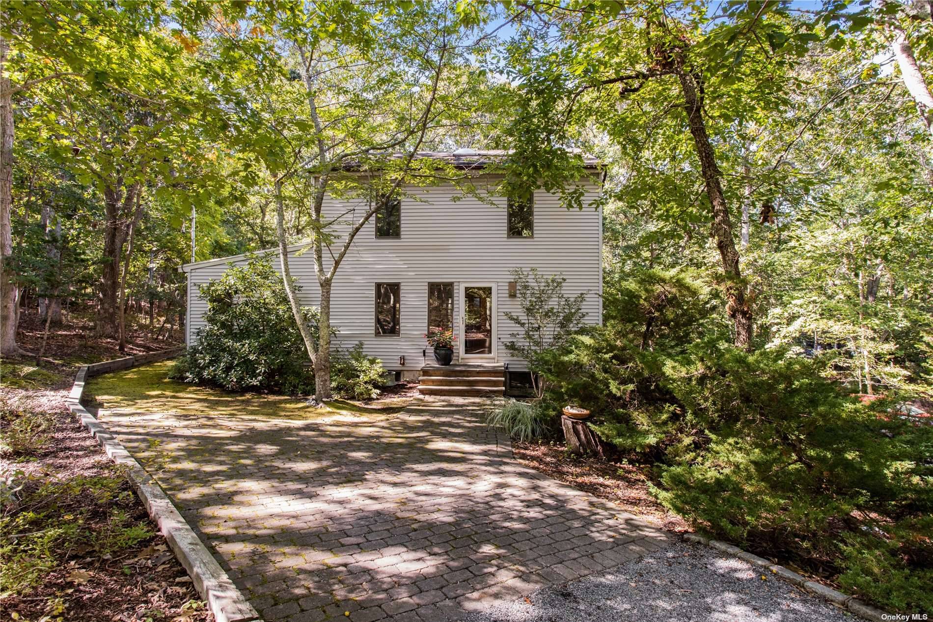 Charming salt box style home on approximately 3 4 acre wooded lot on Nassau Point.